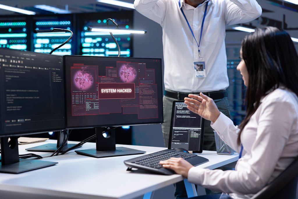 Team of developers in server room dealing with a cybersecurity breach